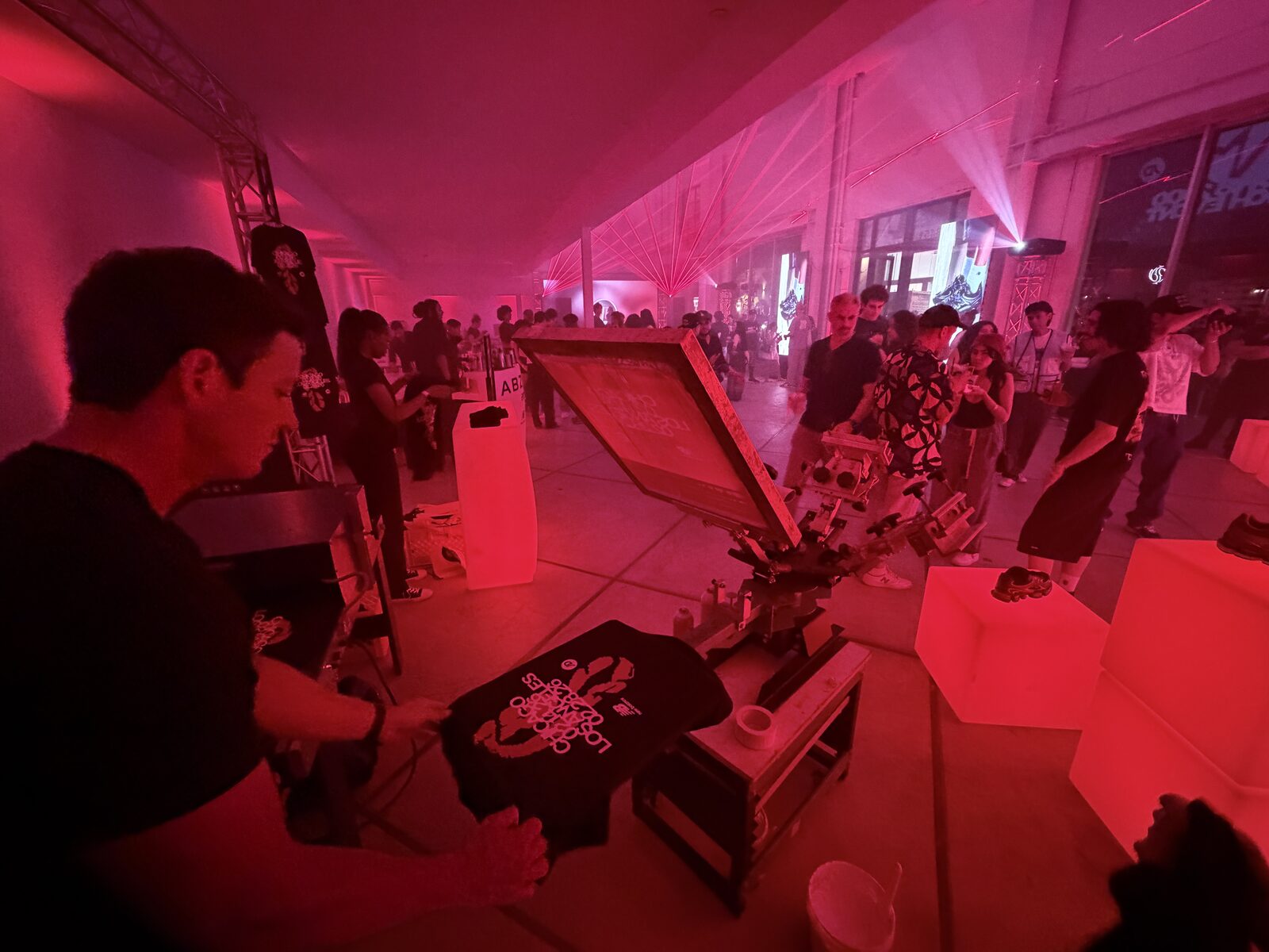 Guest holding a freshly printed custom shirt at a party printing station